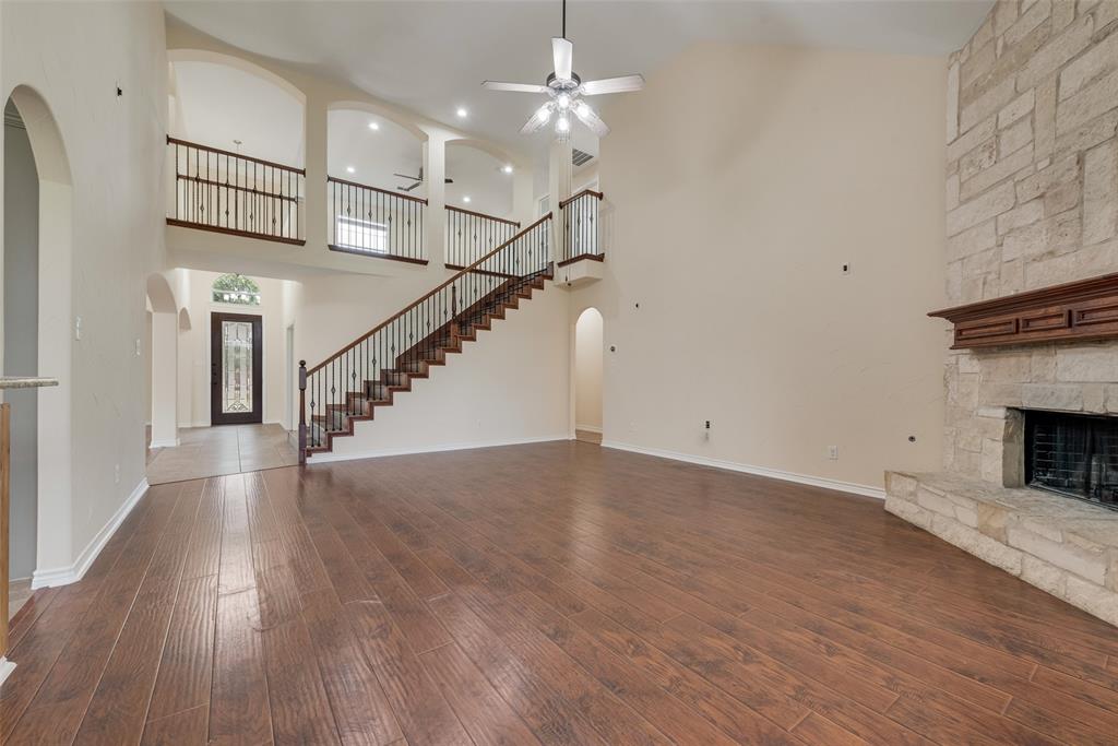 623 Lone Ridge Way Murphy, TX 75094 - Photo 8 of 40 a view of empty room with wooden floor and ceiling fan