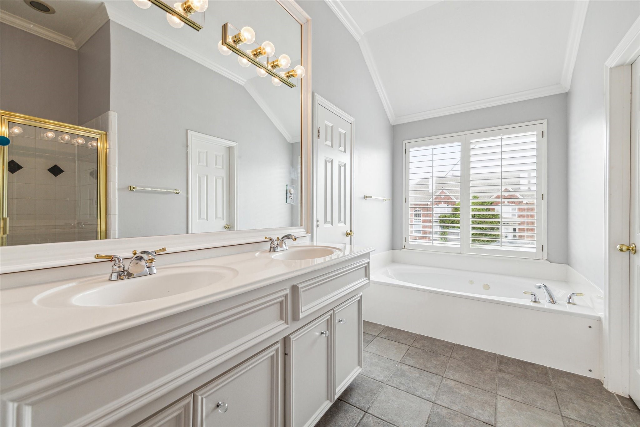 1213 Oneil Street, Unit B Houston, TX 77019 - Photo 17 of 20 a bathroom with a bathtub a sink and a window