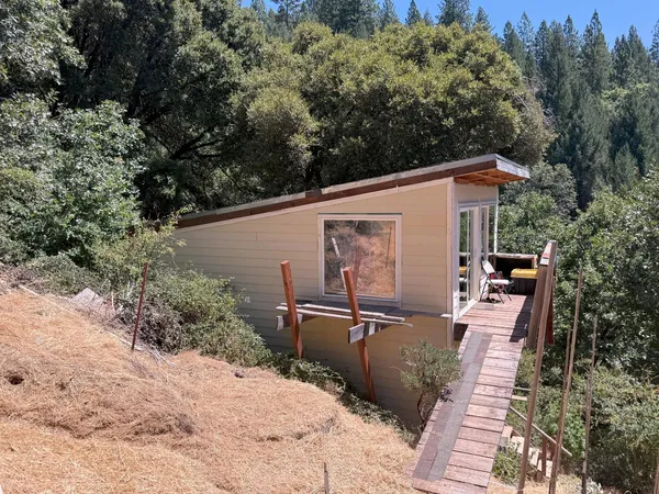 a backyard of a house with table and chairs