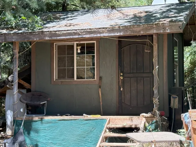 a backyard of a house with table and chairs
