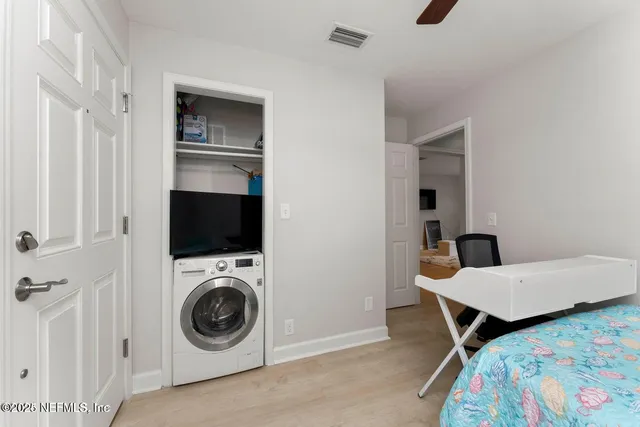 a bedroom with a bed and a television