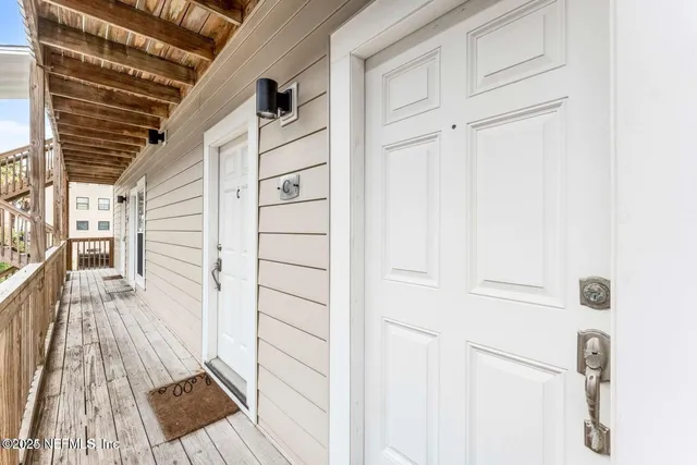 a view of a balcony with wooden floor