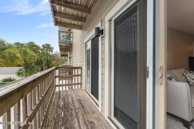 a view of balcony with wooden floor and fence