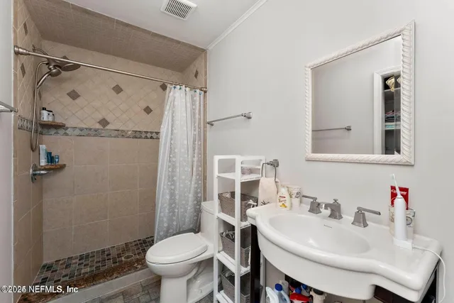 a bathroom with a sink toilet and shower