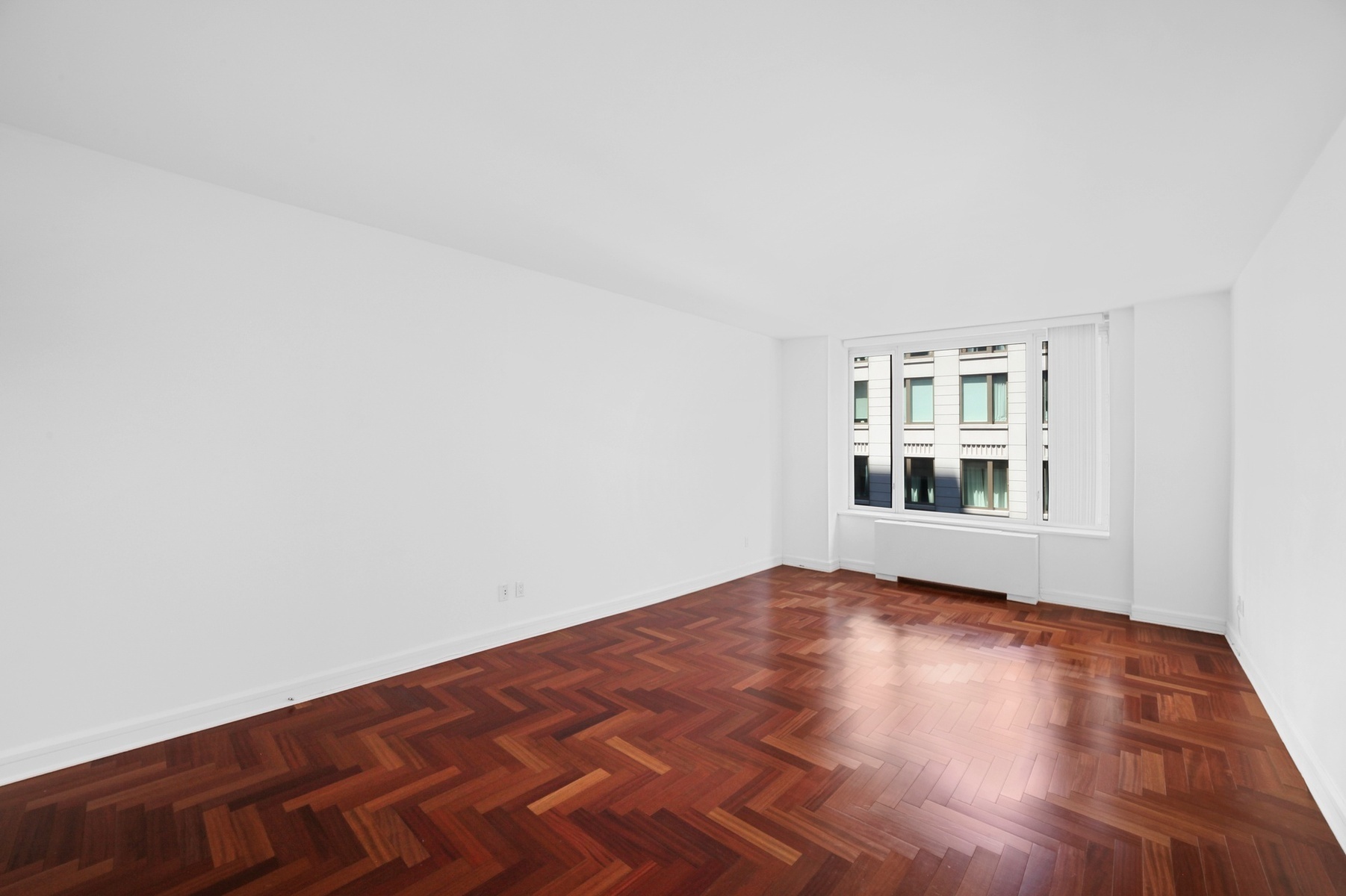 220 Riverside Boulevard, Unit 6T Manhattan, NY 10069 - Photo 6 of 16 a view of empty room with wooden floor and cabinet