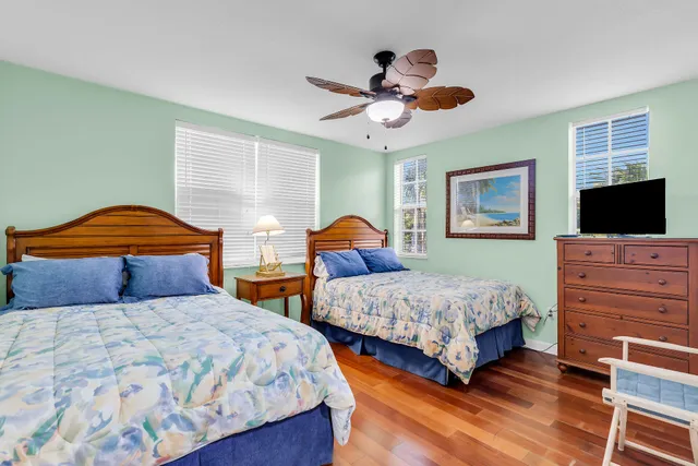 a bedroom with 2 bed and a lamp