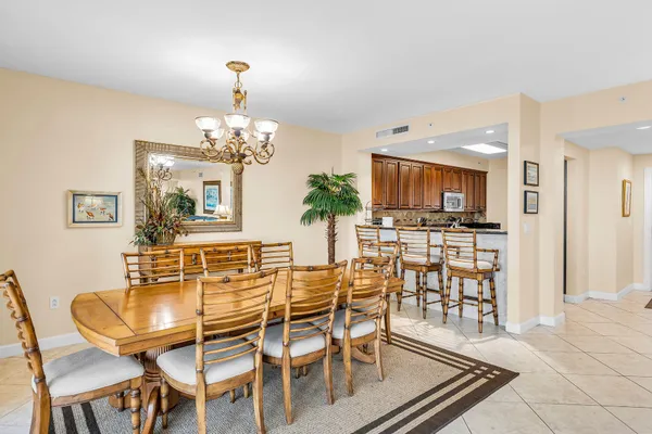 a dining room with wooden floor and chandelier