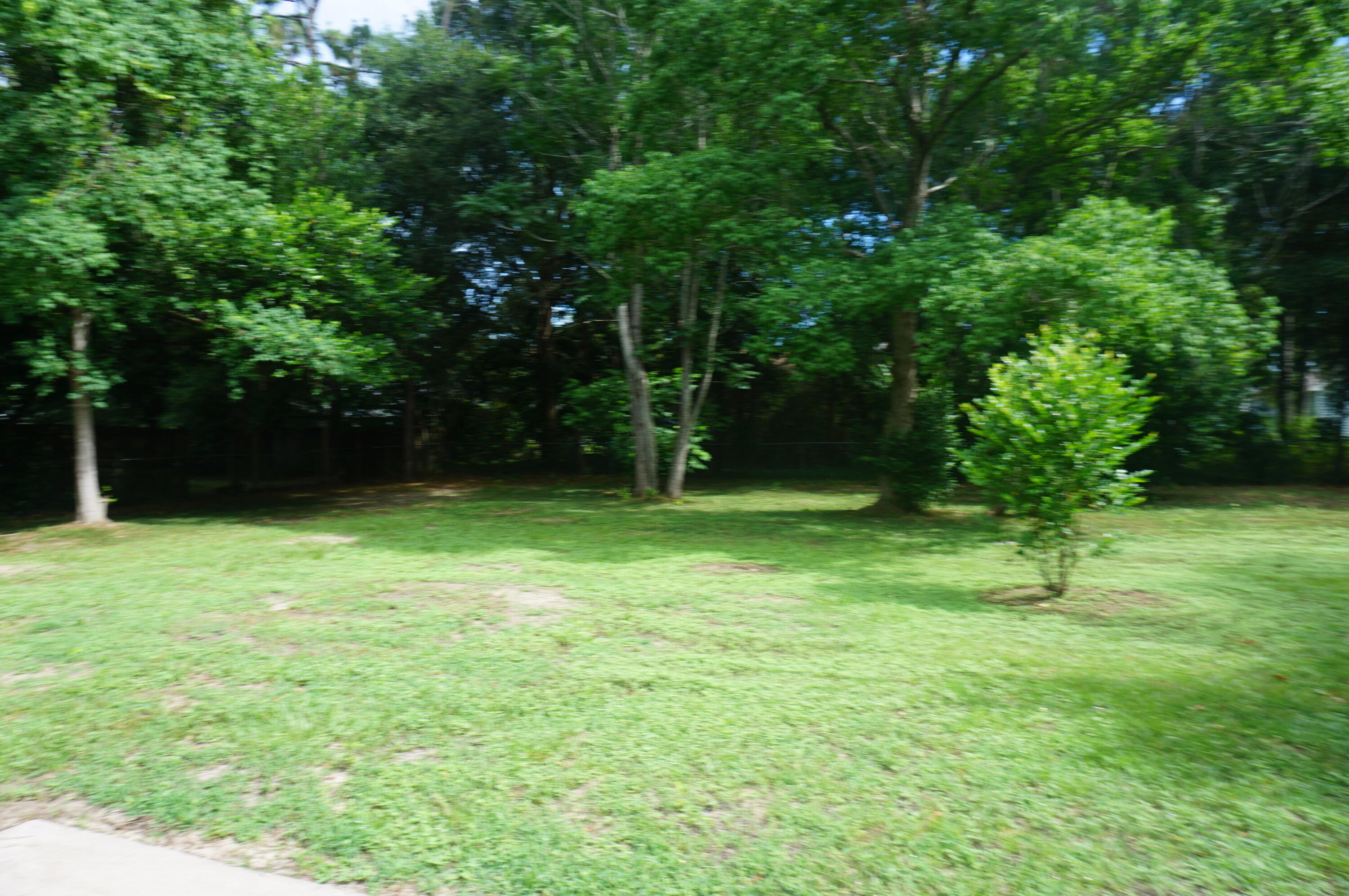 305 Hudson Drive Crestview, FL 32539 - Photo 14 of 16 a backyard of a house with lots of green space