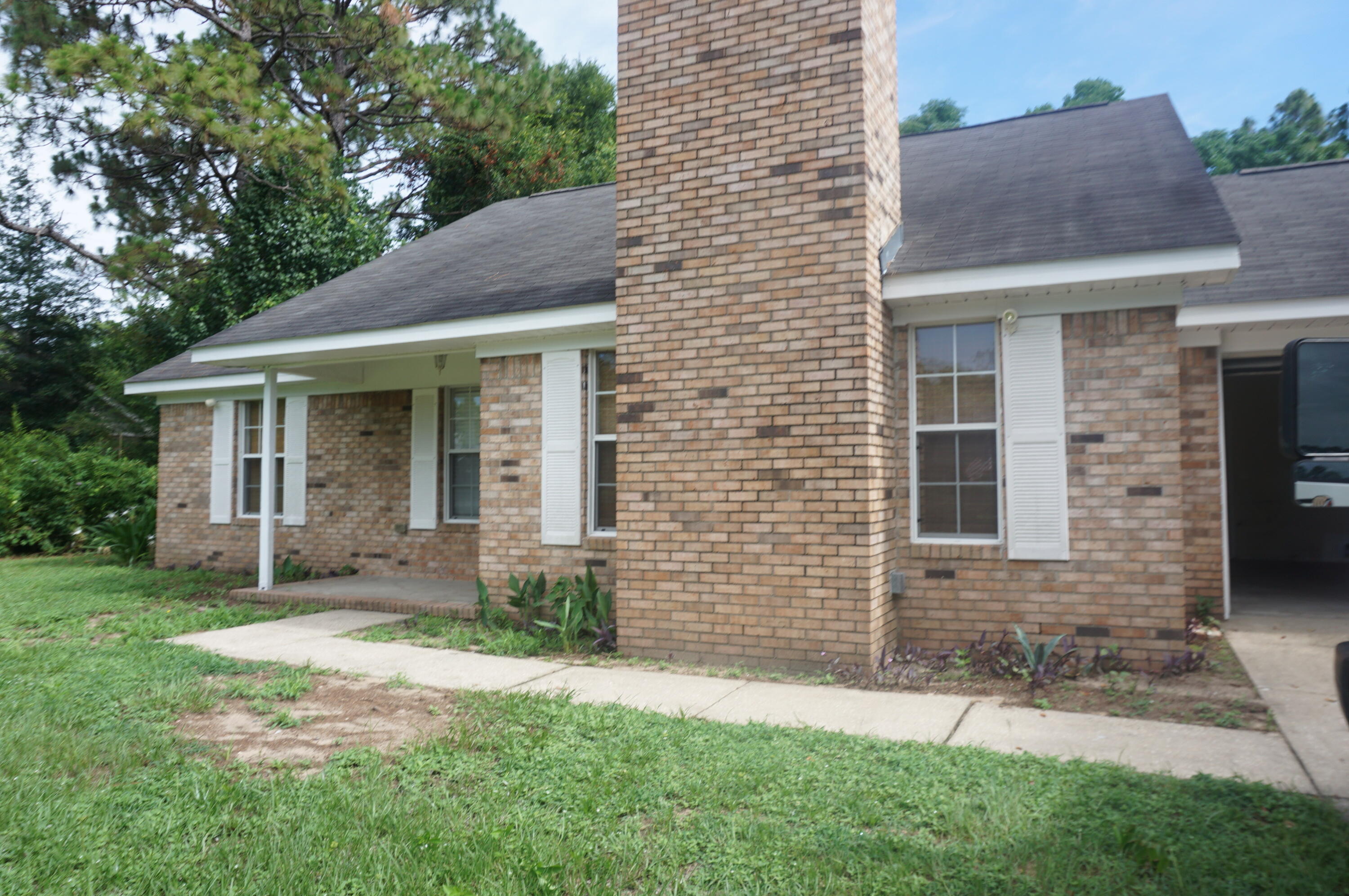 305 Hudson Drive Crestview, FL 32539 - Photo 15 of 16 a front view of a house with a garden and yard