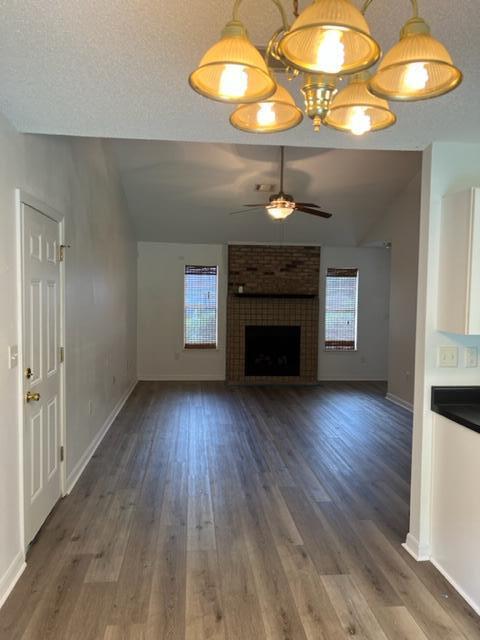 305 Hudson Drive Crestview, FL 32539 - Photo 5 of 16 a view of an empty room with a fireplace and wooden floor