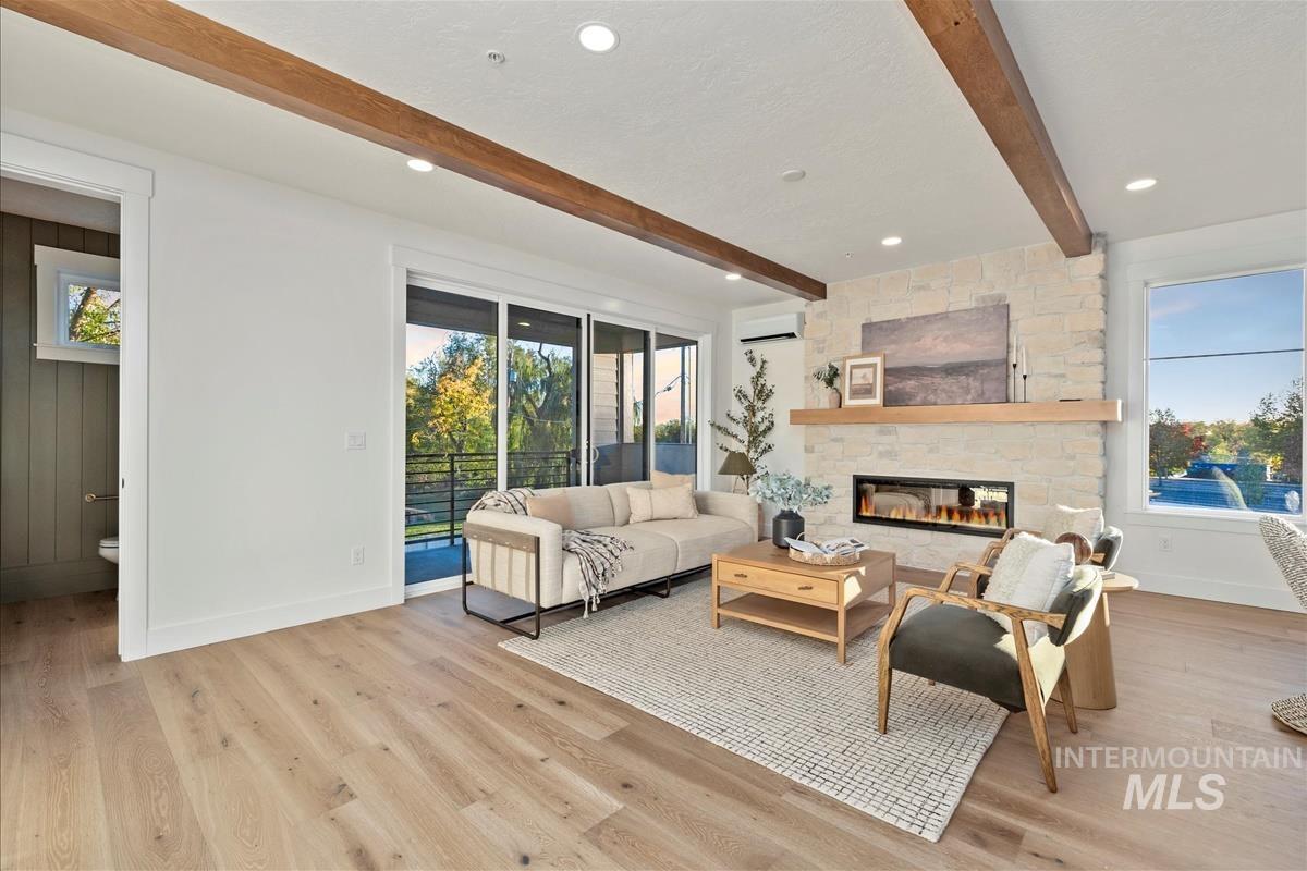 3243 West Moore Street Boise, ID 83702 - Photo 9 of 38 Living room featuring beamed ceiling, plenty of natural light, a fireplace, light wood-type flooring, and recessed lighting