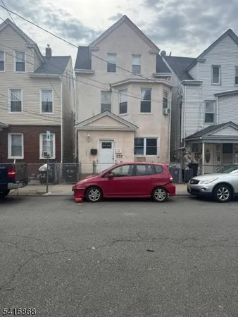 a view of a cars park in front of a building