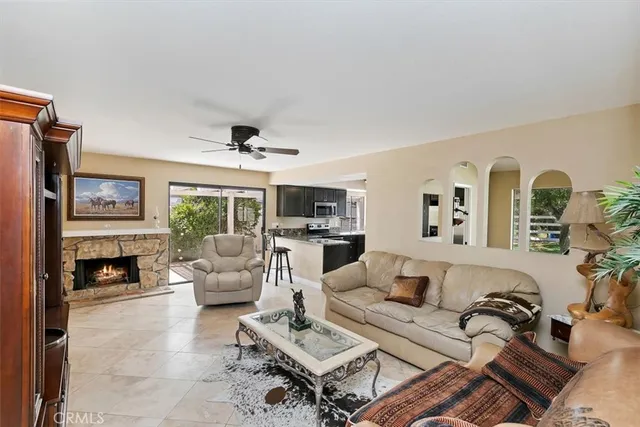 a kitchen with granite countertop a refrigerator and a stove top oven