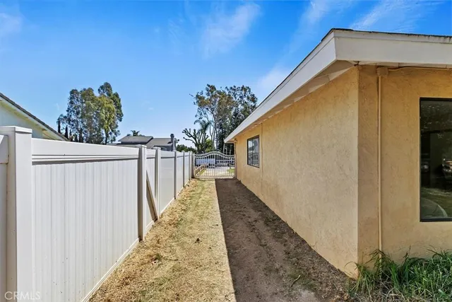 a porch with chairs and next to a yard
