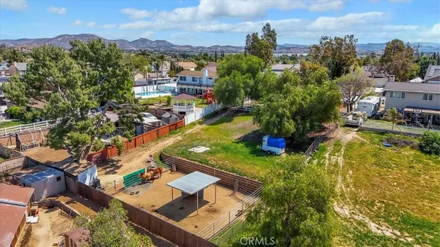 an aerial view of a house with a yard and garden