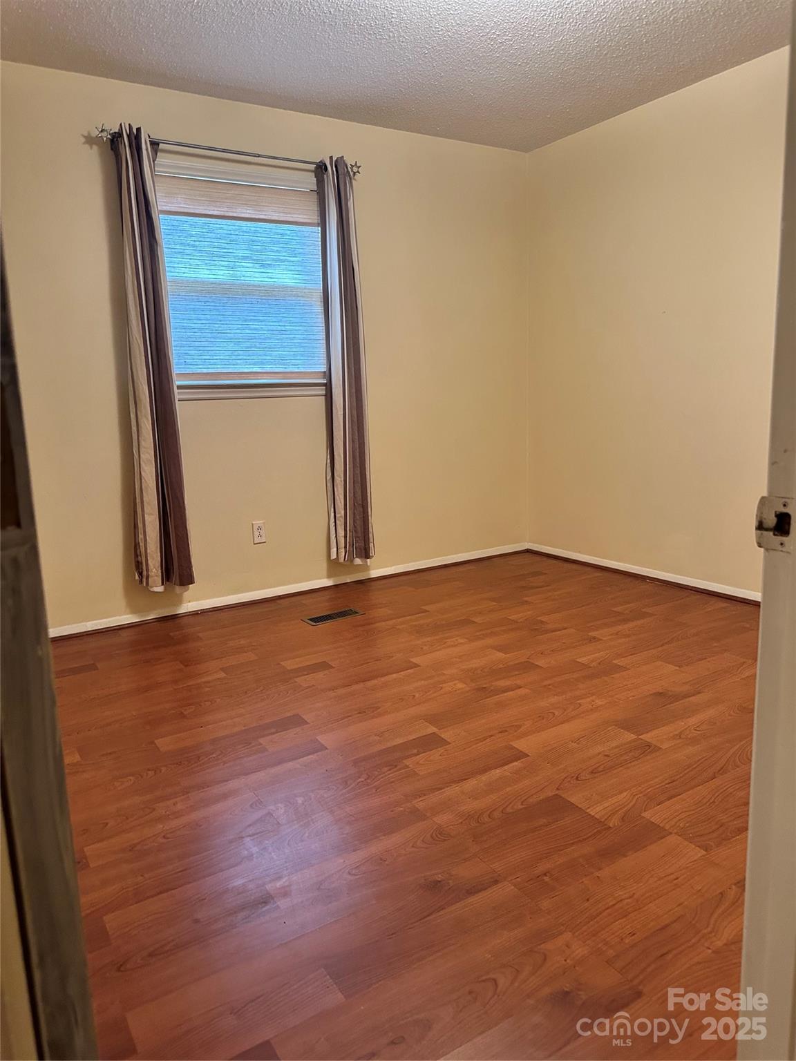 5079 Archdale Drive Conover, NC 28613 - Photo 19 of 30 an empty room with a wooden door and mirror