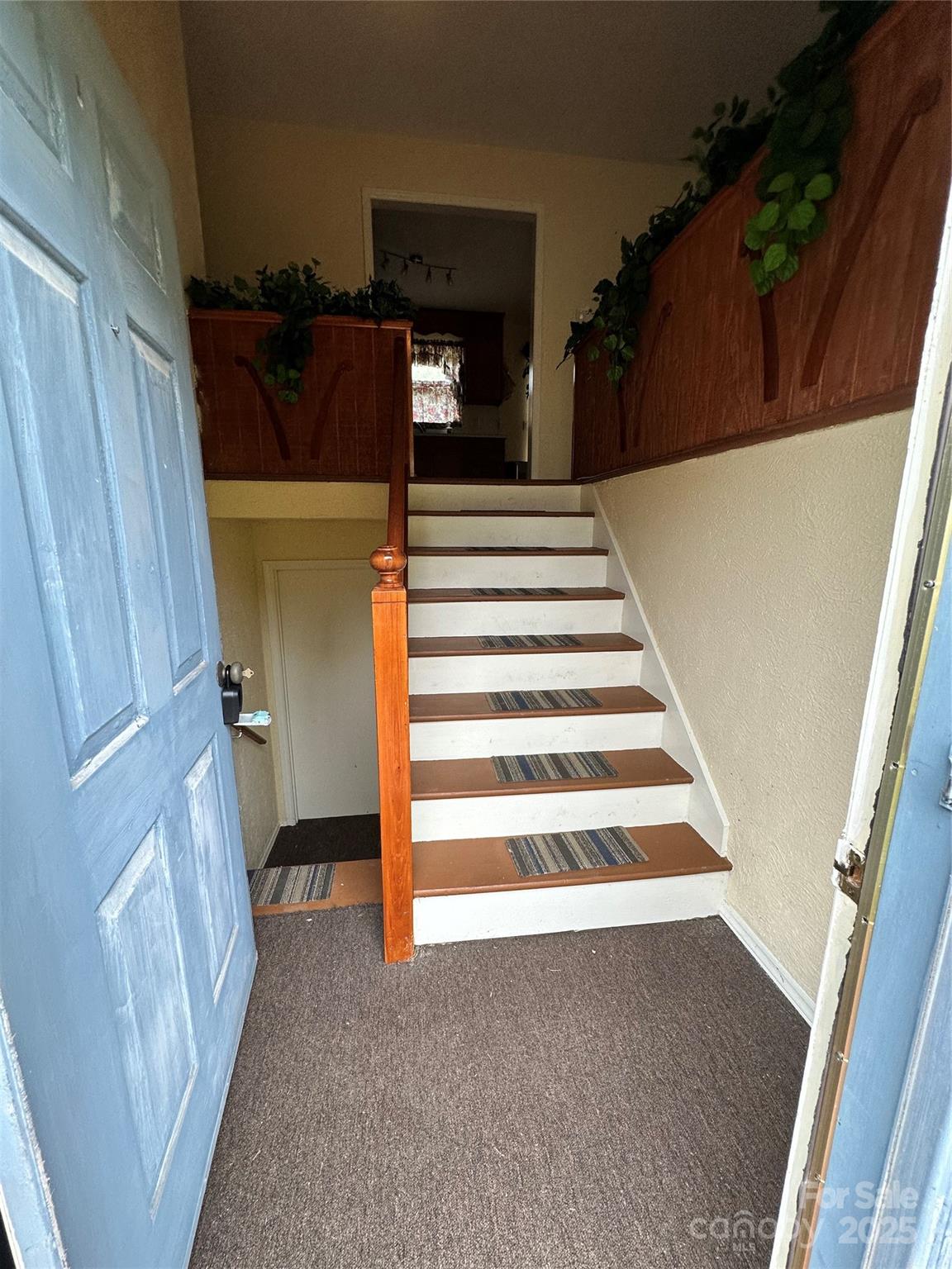 5079 Archdale Drive Conover, NC 28613 - Photo 5 of 30 a view of a stairs and an empty room with wooden floor