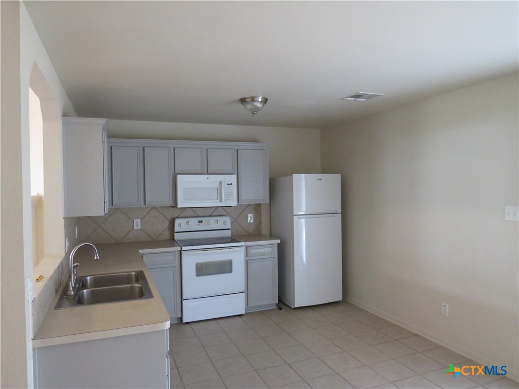 3607 Starfish Drive Killeen, TX 76549 - Photo 8 of 16 a kitchen with a stove sink and refrigerator