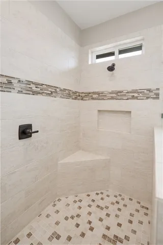 an aerial view of residential houses with outdoor space and ocean view