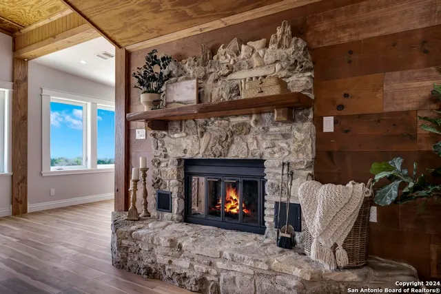 a living room with a fireplace with wooden floor