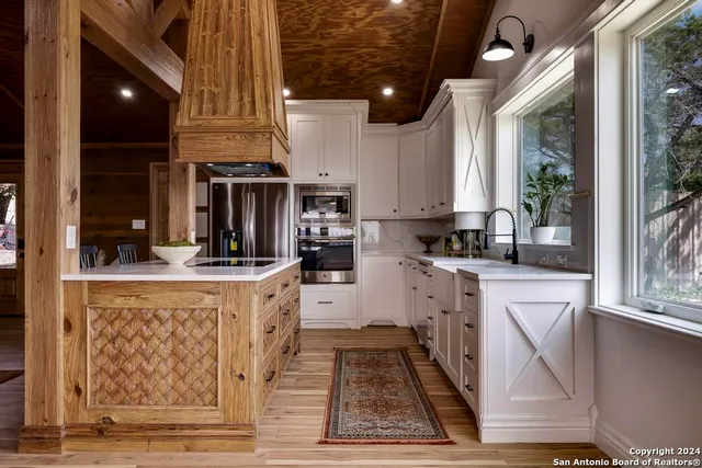a kitchen with stainless steel appliances granite countertop a stove a sink and a refrigerator