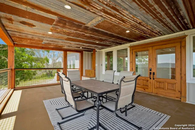 a view of an empty room with large windows