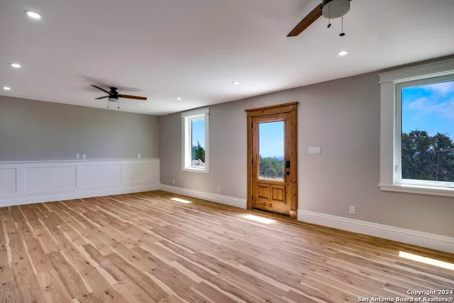 a view of empty room with wooden floor
