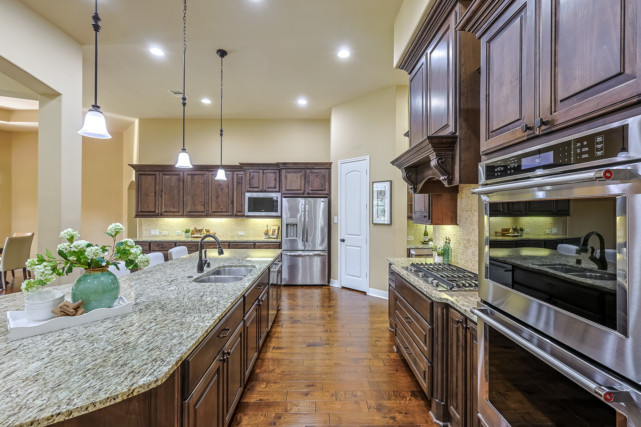 515 Mill Creek Road Pinehurst, TX 77362 - Photo 21 of 48 The island provides ample workspace and seating, while pendant lighting adds a warm ambiance.