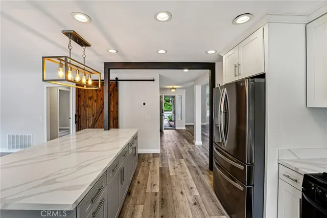 a kitchen with stainless steel appliances a refrigerator and a sink