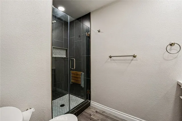 a bathroom with a shower and toilet
