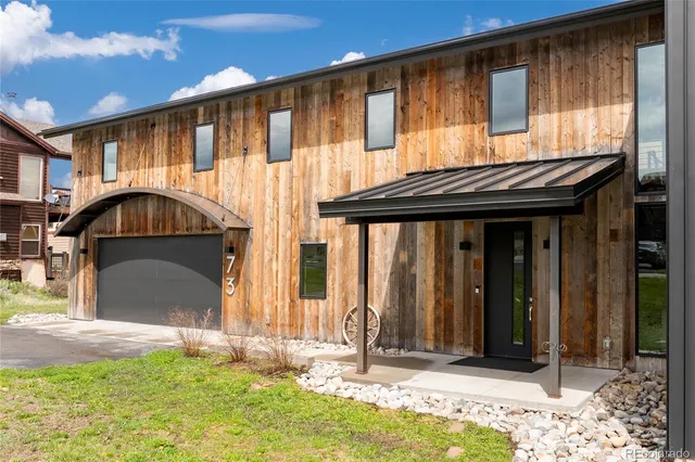 a view of a house with backyard porch and sitting area