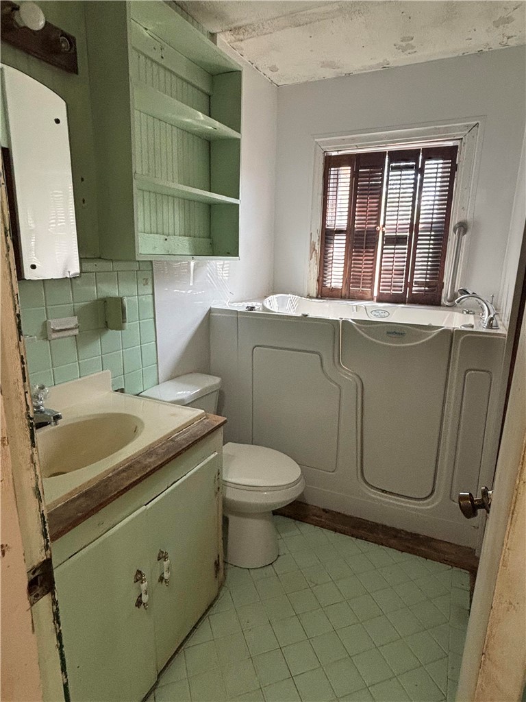 369 Edith Drive Alice, TX 78332 - Photo 16 of 27 a bathroom with a sink toilet and mirror