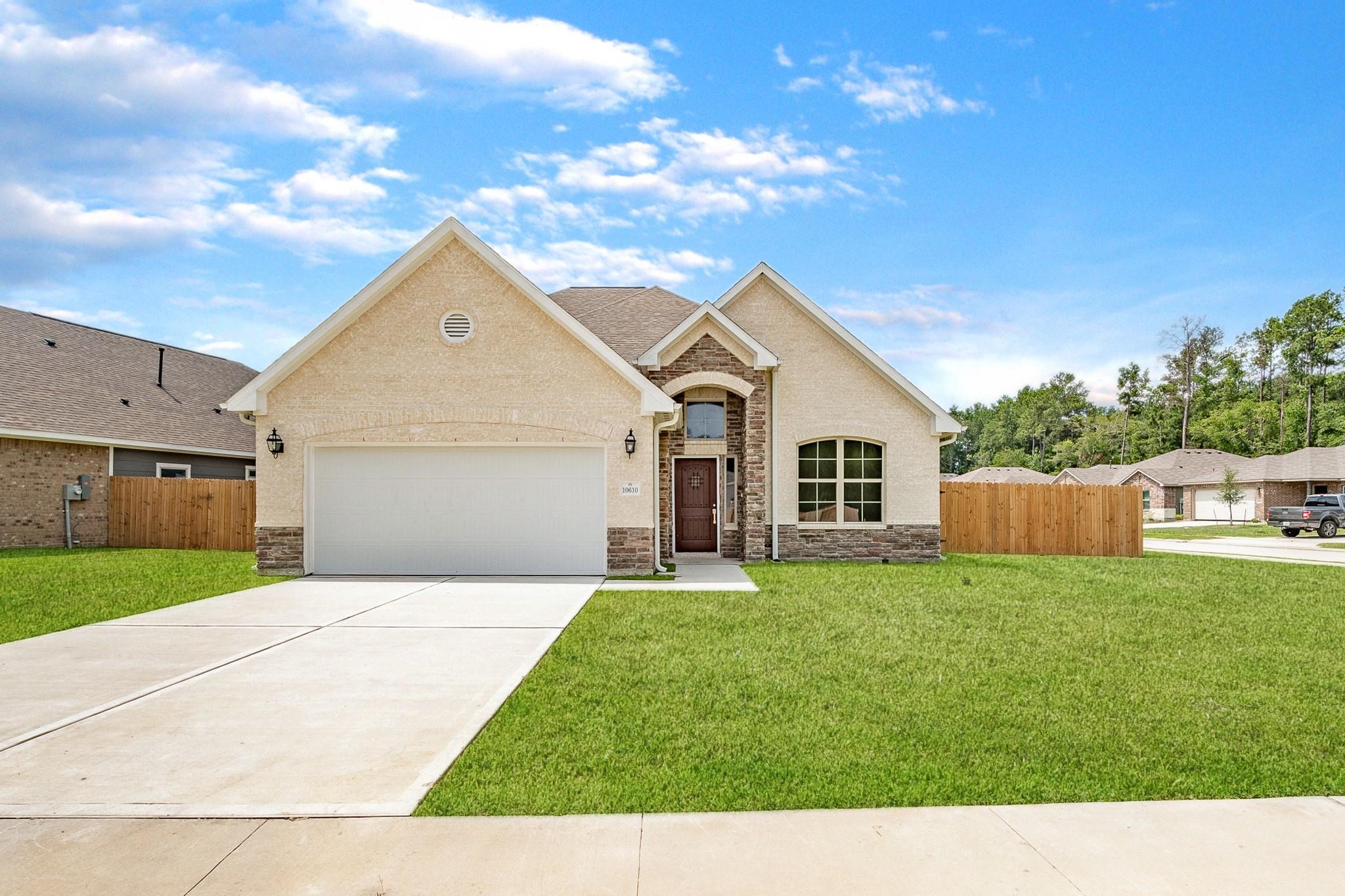 a front view of a house with a yard and garage