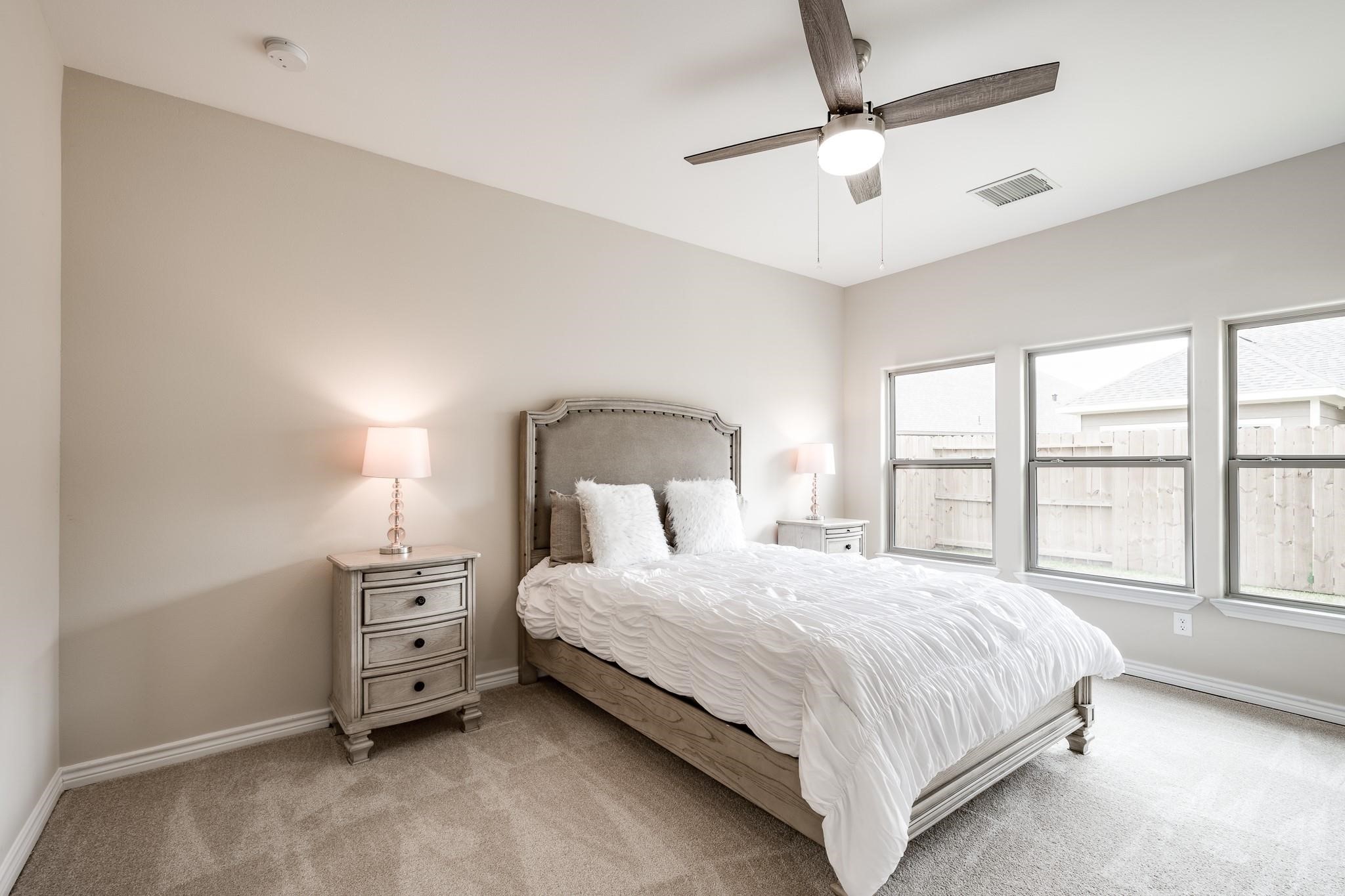 10610 Ellerston Road Cleveland, TX 77327 - Photo 11 of 26 a bedroom with a bed and a large window