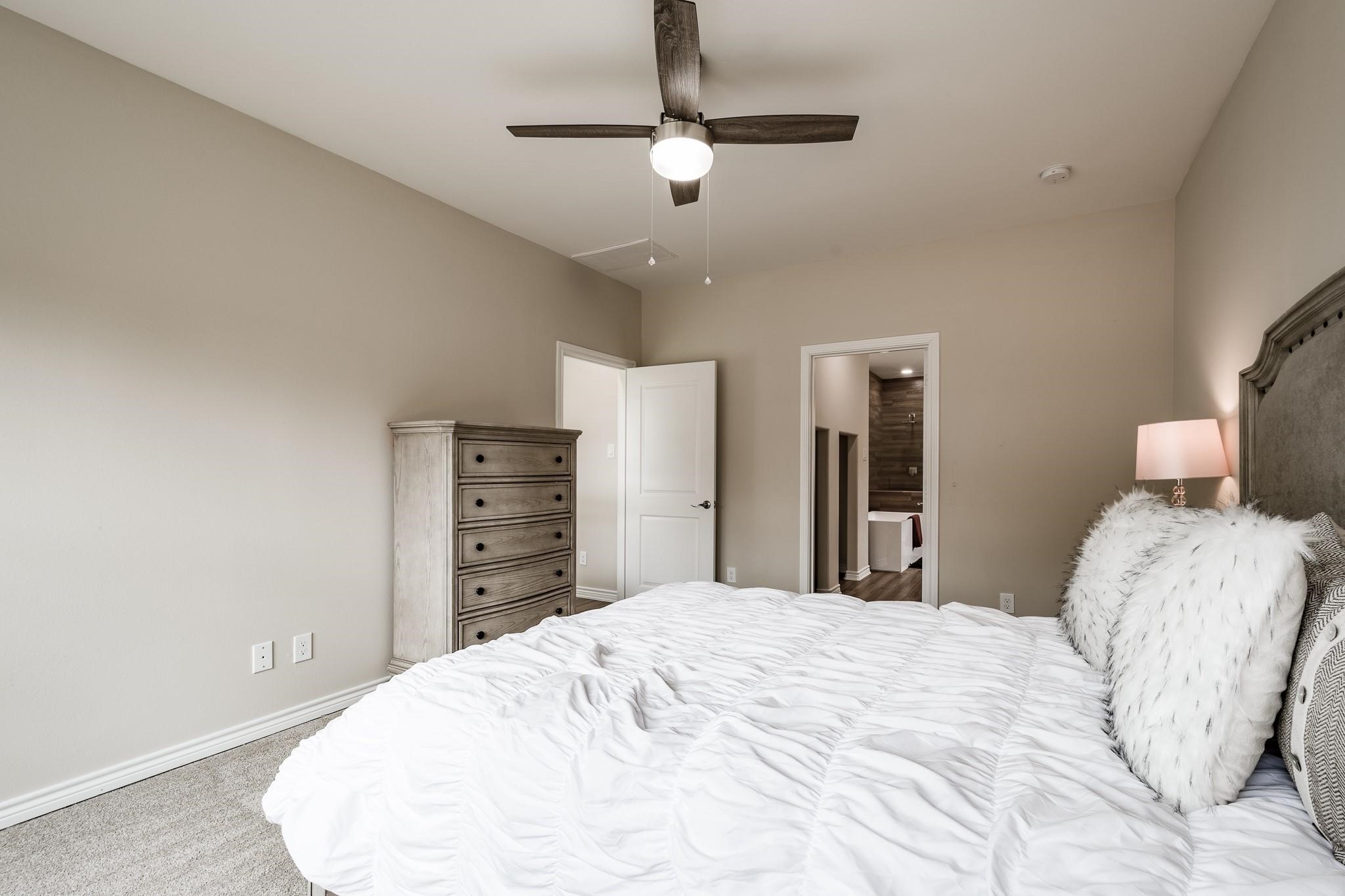 10610 Ellerston Road Cleveland, TX 77327 - Photo 12 of 26 a bedroom with a bed and a dresser