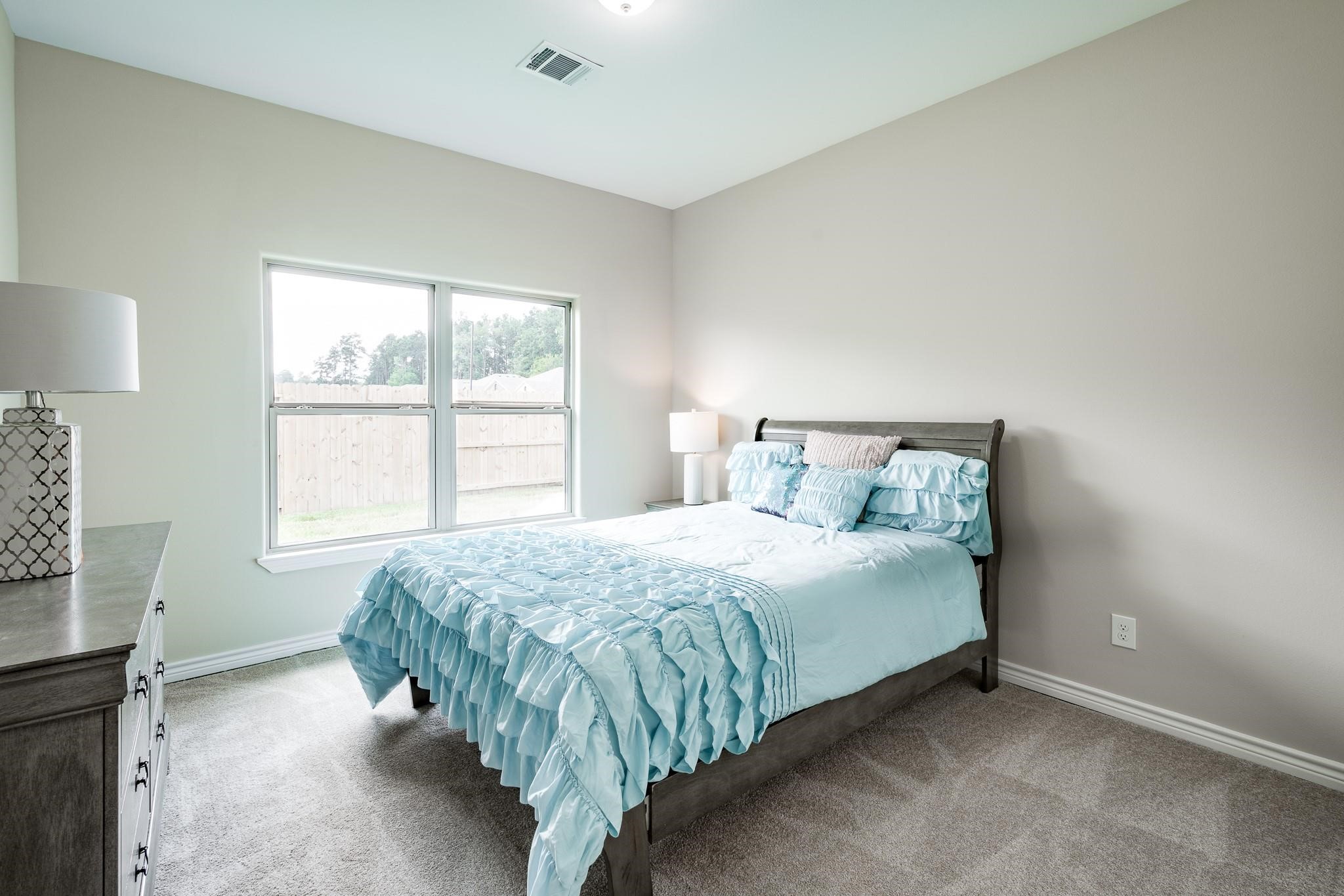 10610 Ellerston Road Cleveland, TX 77327 - Photo 15 of 26 a bed sitting in a bedroom next to a window