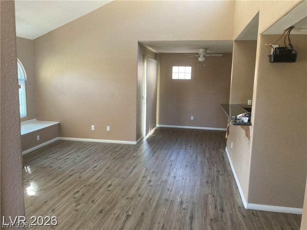 3145 East Flamingo Road, Unit 2100 Las Vegas, NV 89121 - Photo 9 of 34 A versatile living area features durable flooring, a convenient breakfast bar, and a charming arched window.