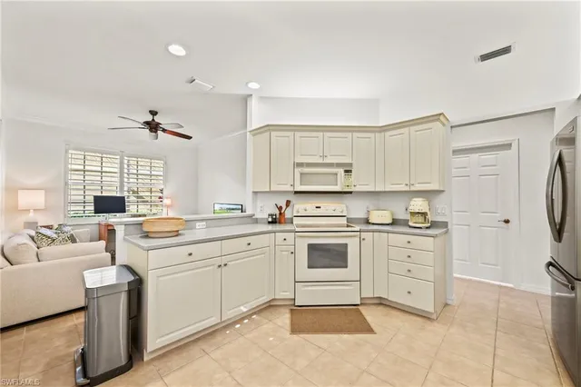 a kitchen with a stove top oven sink and cabinets