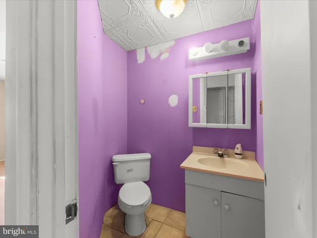 a bathroom with a sink mirror vanity and toilet