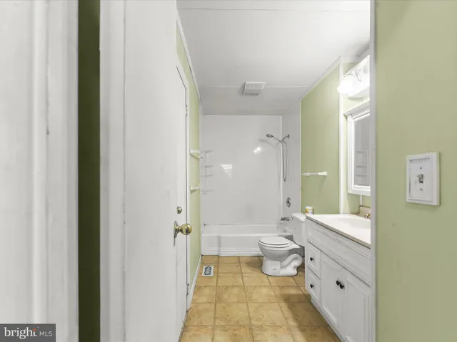 a bathroom with a double vanity sink toilet and shower