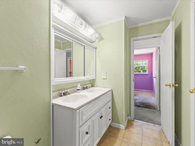 a bathroom with a sink a vanity and a mirror