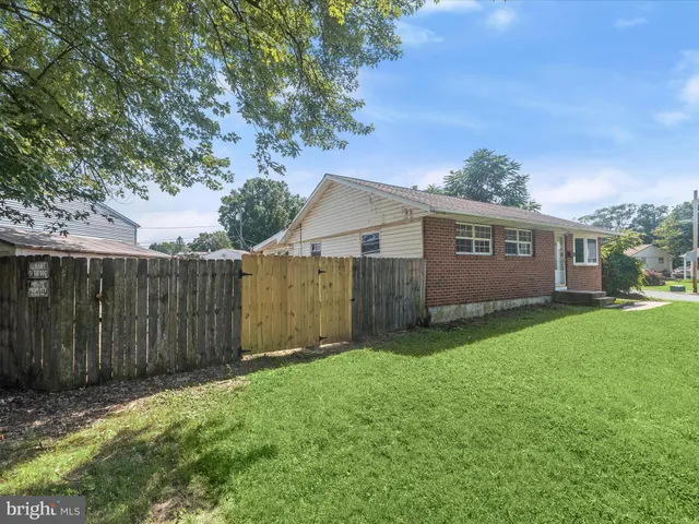 a view of backyard with potted plants and wooden fence
