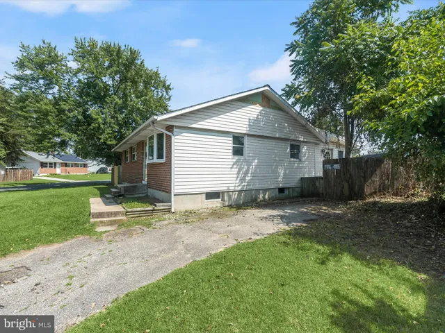 a view of a backyard with a garden and entertaining space