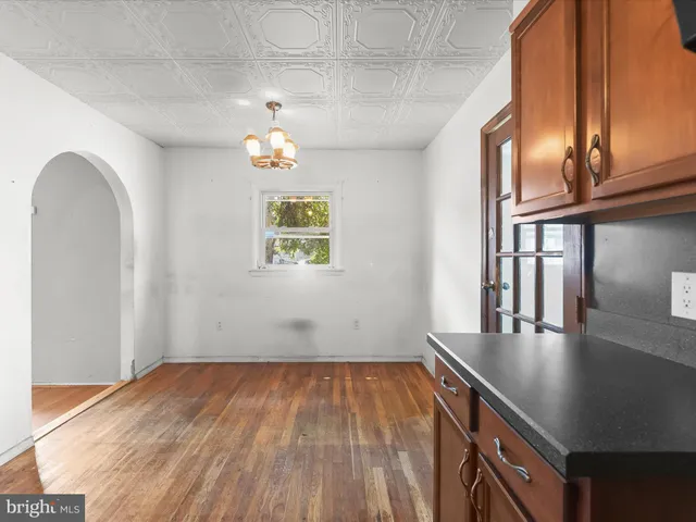 a view of a livingroom with wooden floor and a ceiling fan