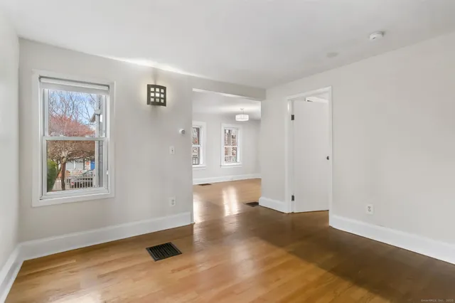 a view of empty room with wooden floor