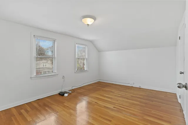 a view of a room with wooden floor and windows