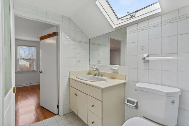 a bathroom with a toilet sink and mirror