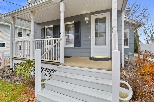 a view of front door of house with stairs