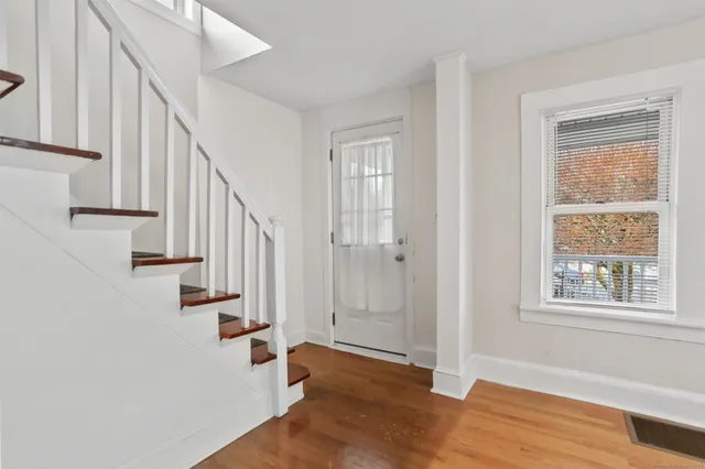 a view of entryway with wooden floor and stair