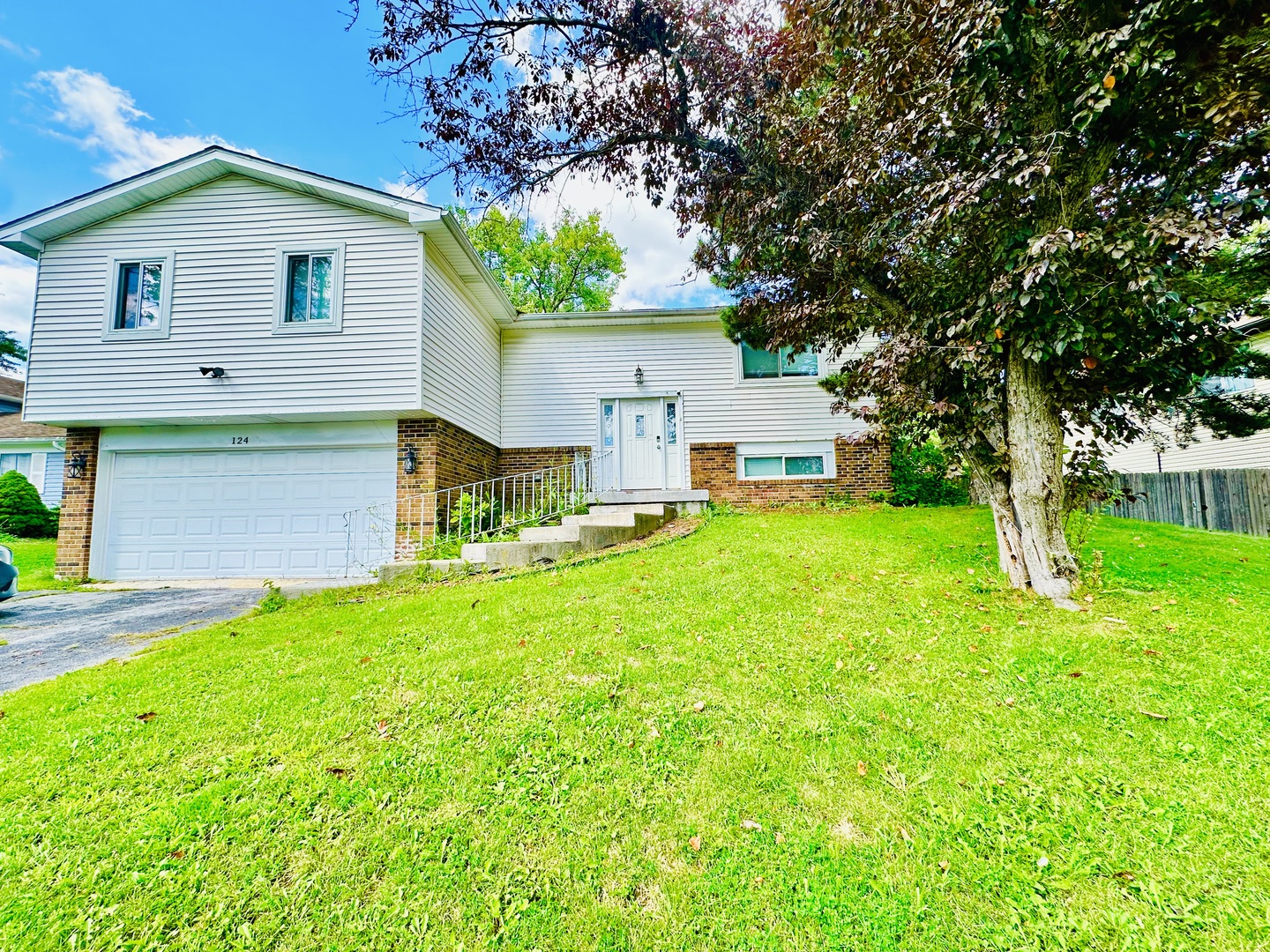 a front view of house with yard and green space